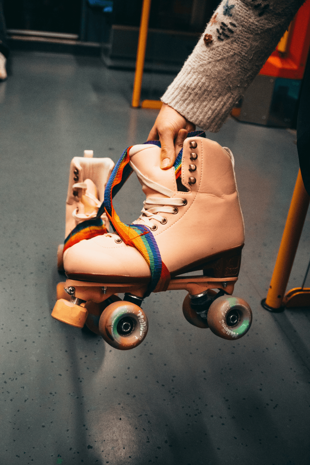 Child holding a pair of retro roller boots
