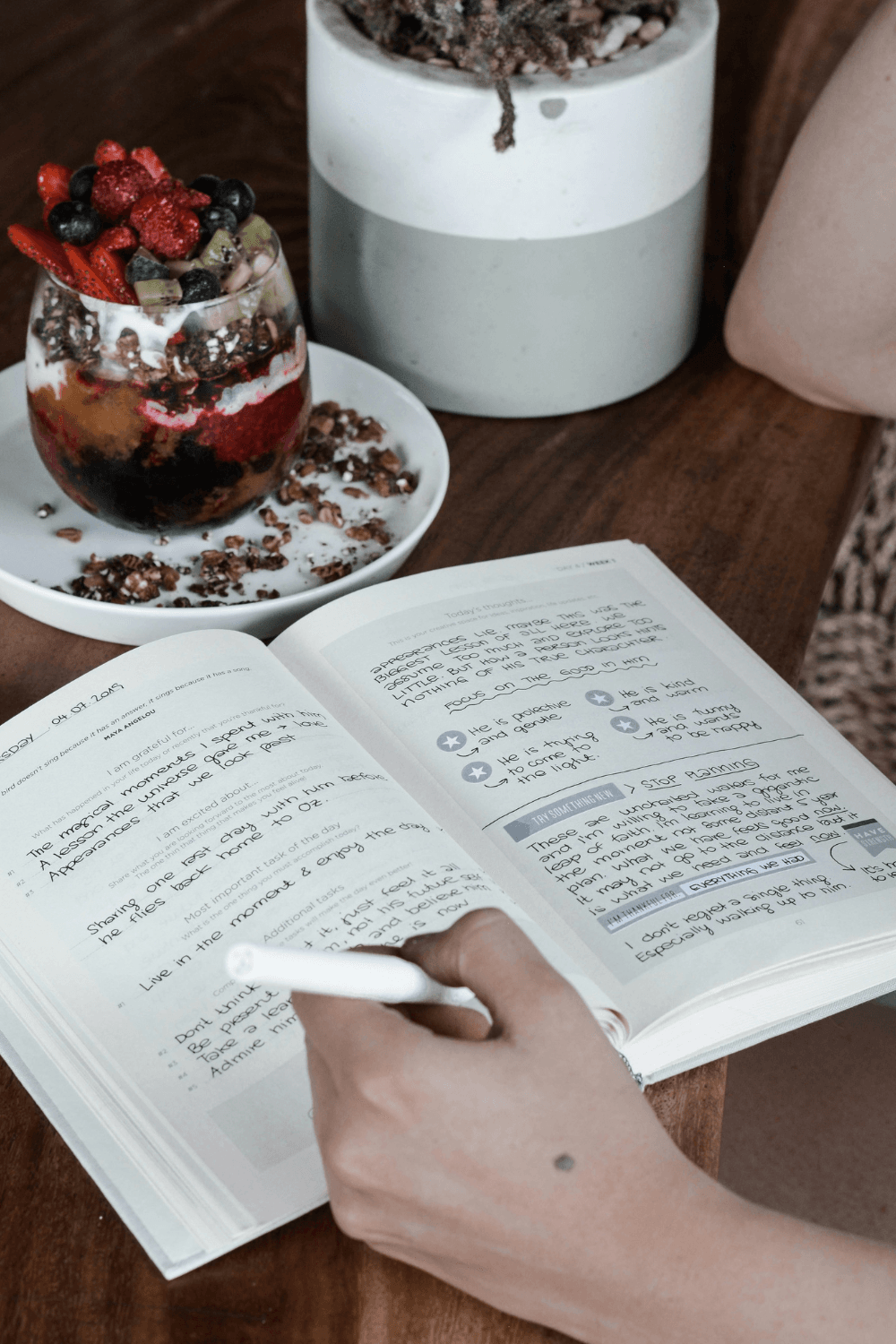 Close-up of woman writing notes in journal