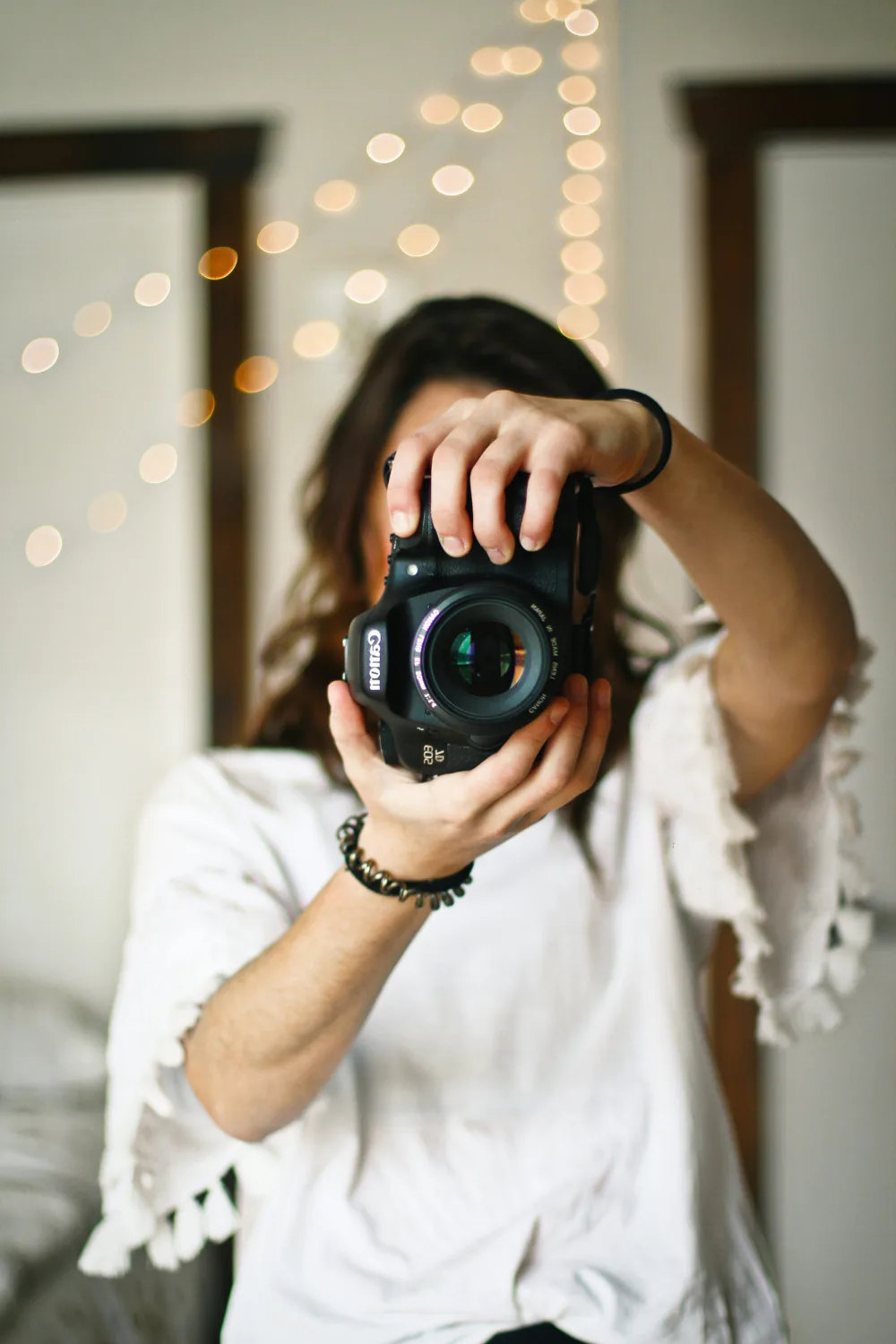 Female photographer holding Canon camera