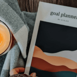Goal planner magazine next to candle