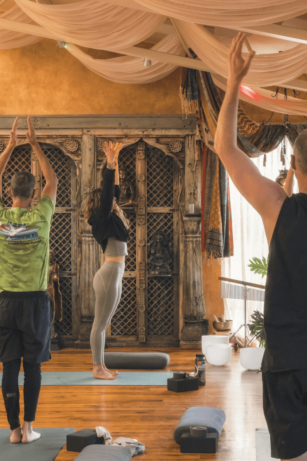 Group of people doing yoga in a studio