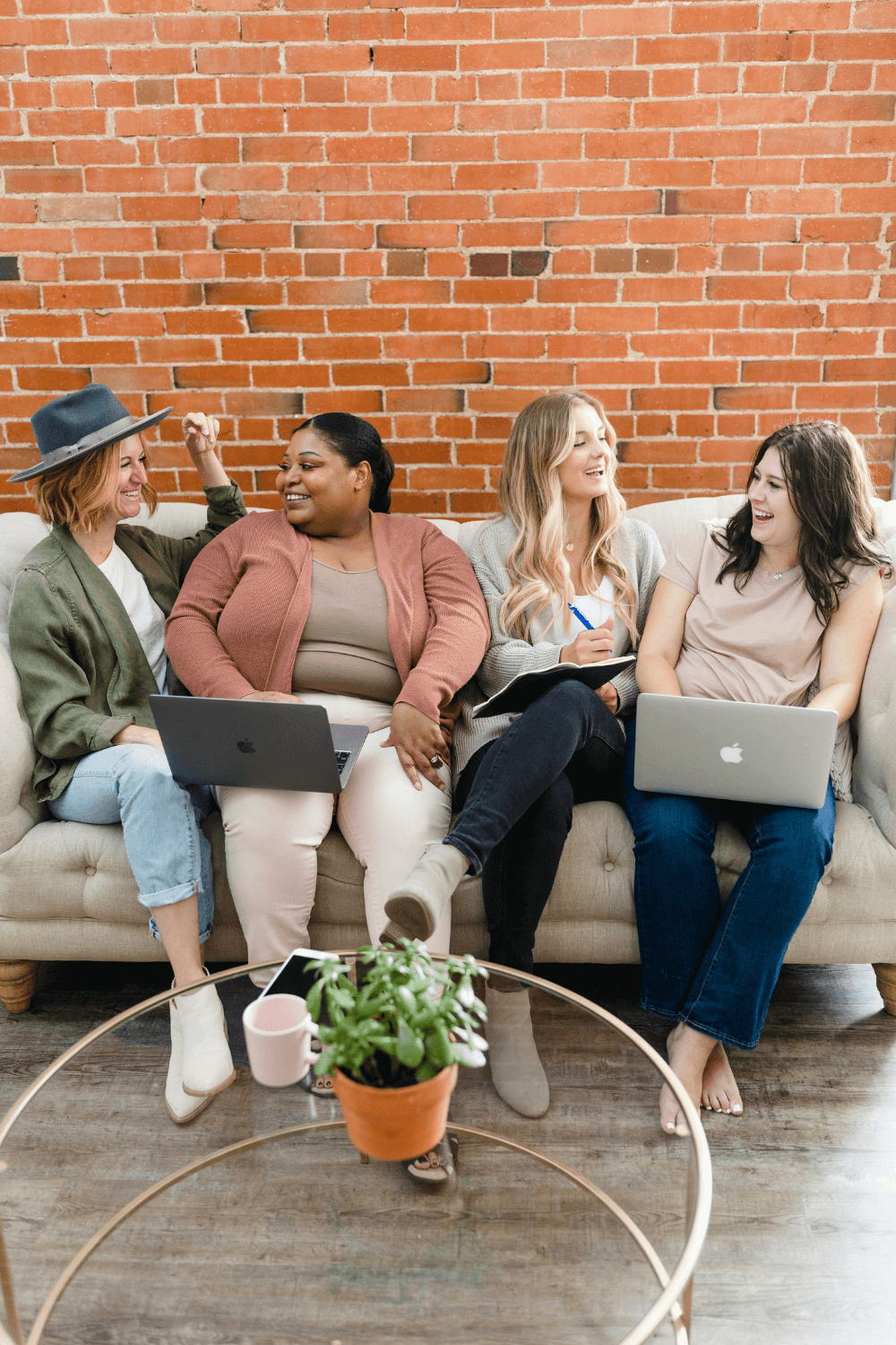 Group of smiling women sitting on a sofa