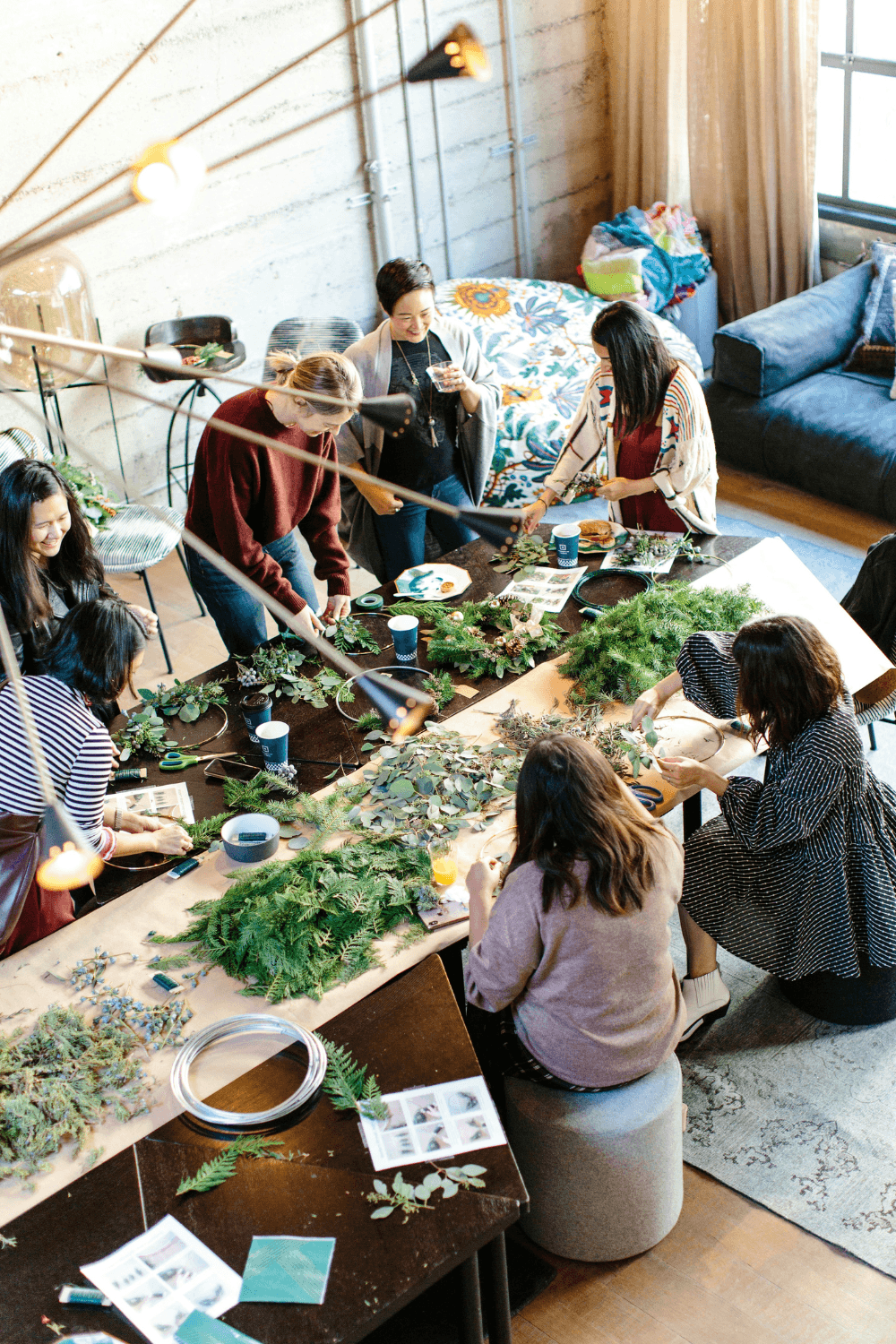 Group of women arranging fallen leaves on long table