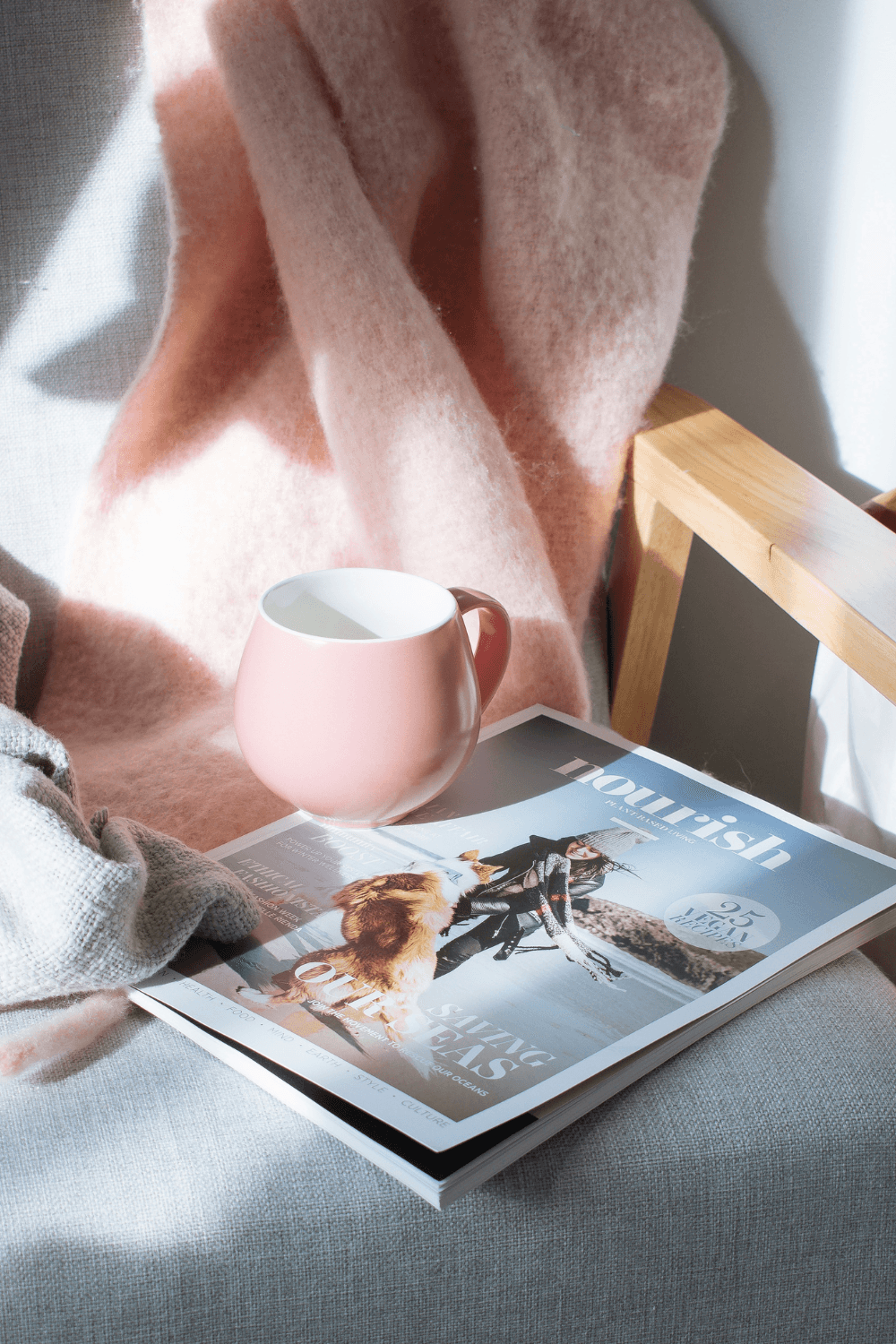 Pink blanket pink mug and nourish magazine