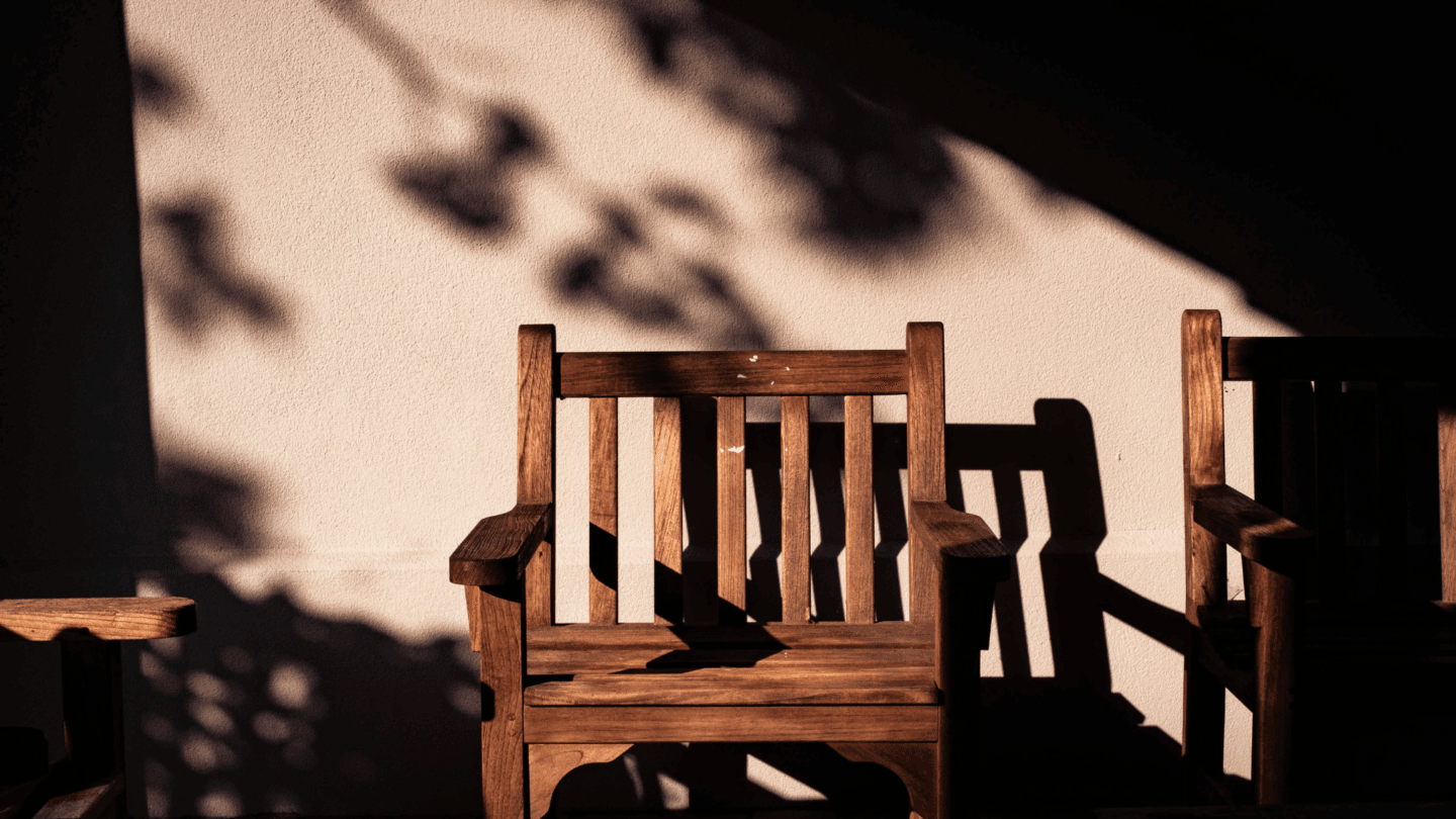 Rays of light shining on empty chair