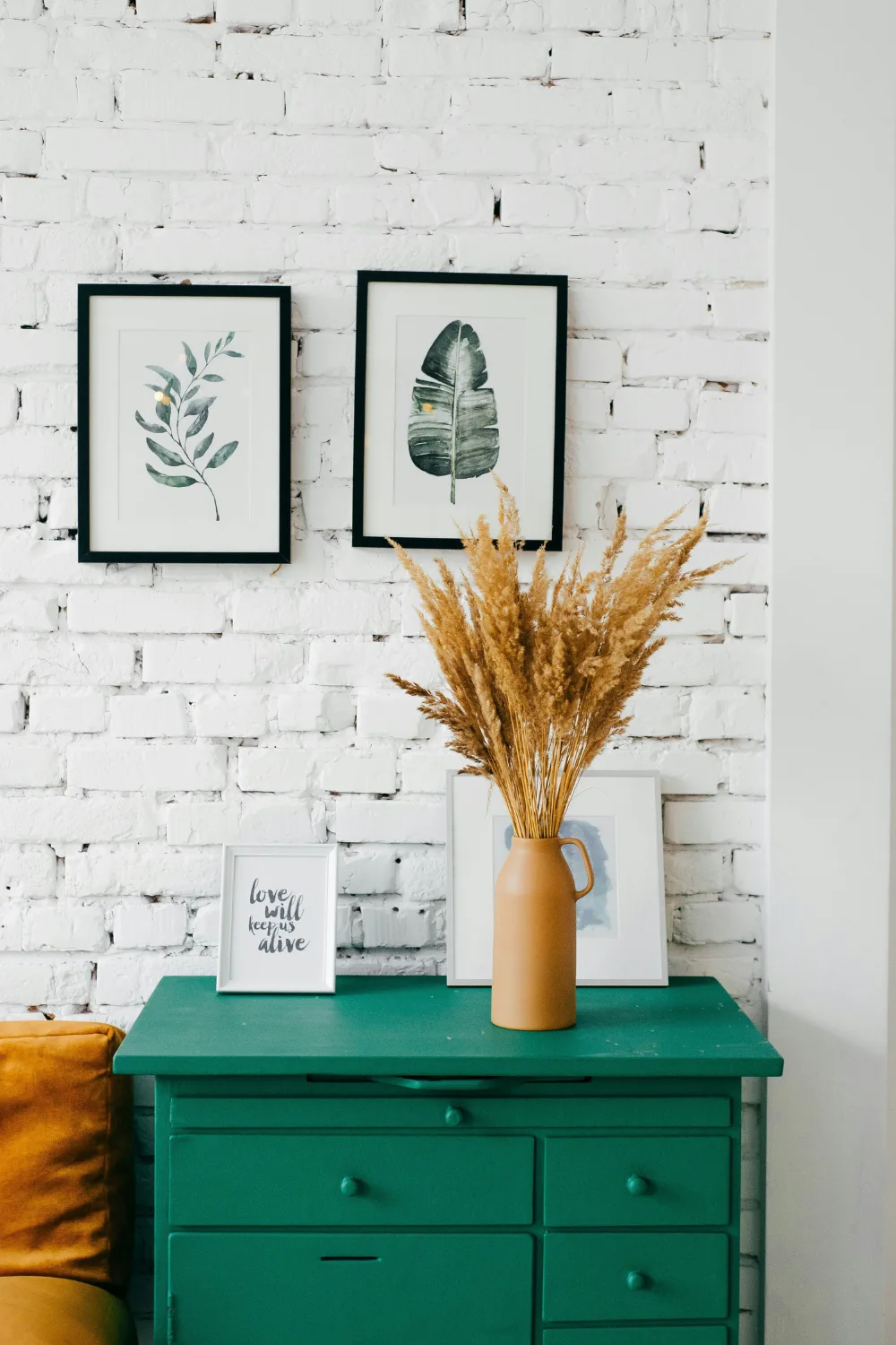 Room with white brick and green drawers