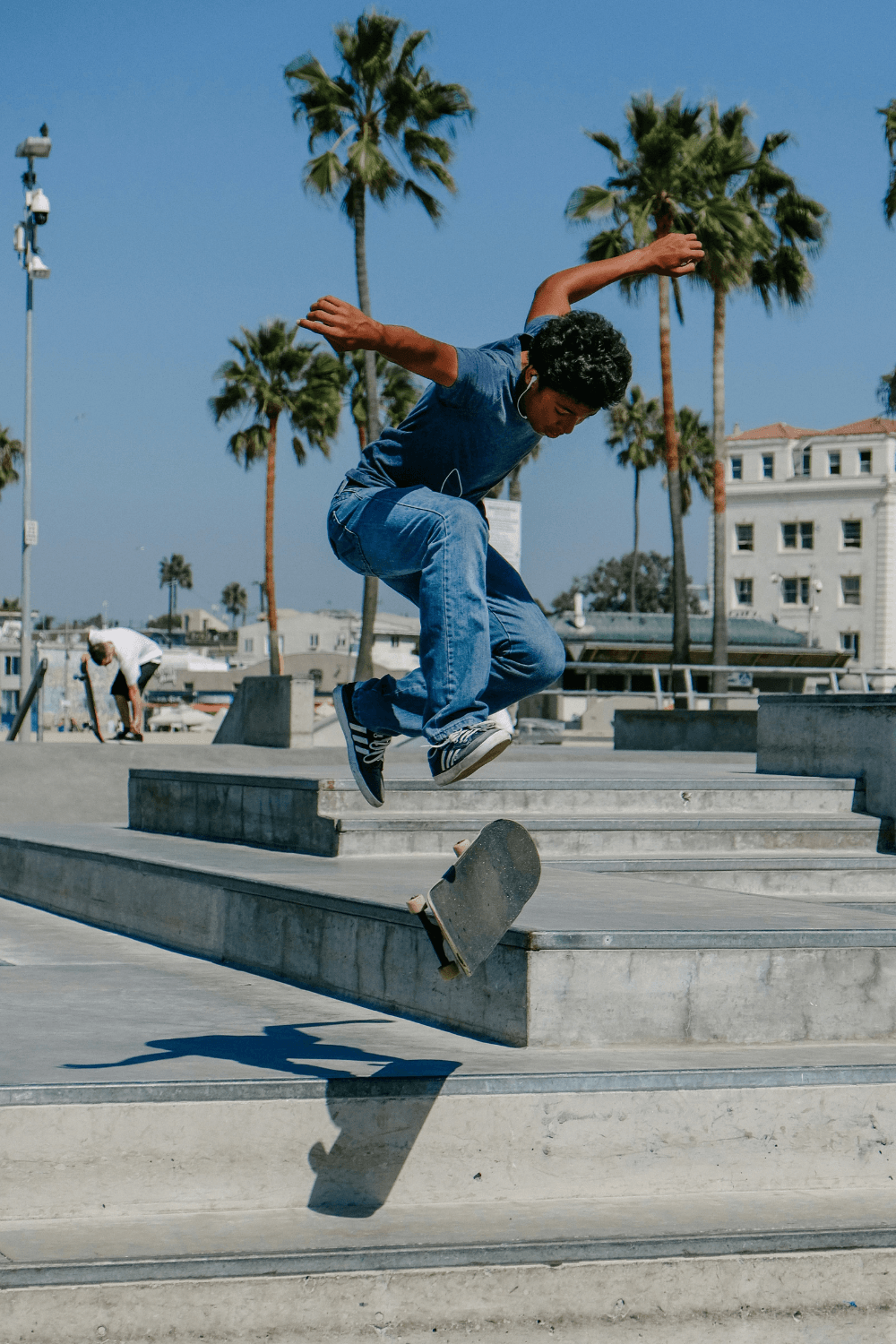 Skateboarder jumping down steps