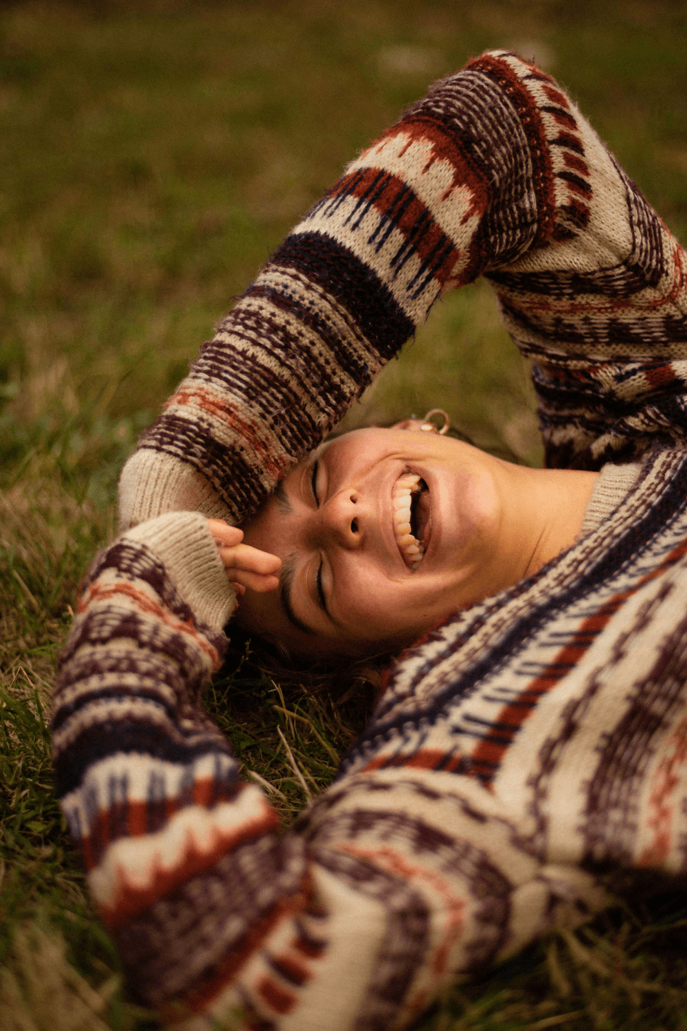 Smiling young woman lying on the grass