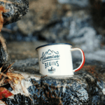 The adventure begins camping mug in stream