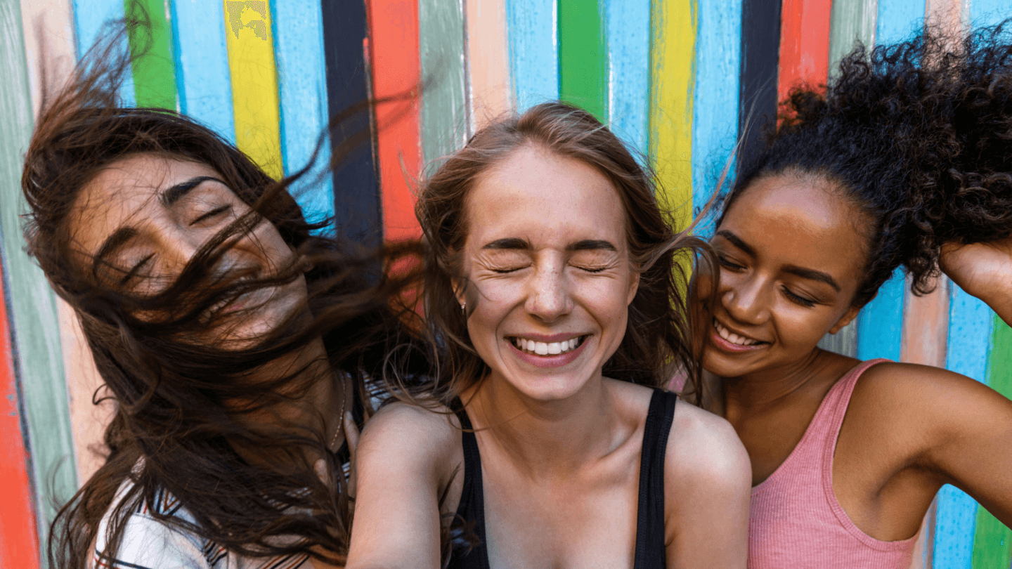 Three girls laughing together