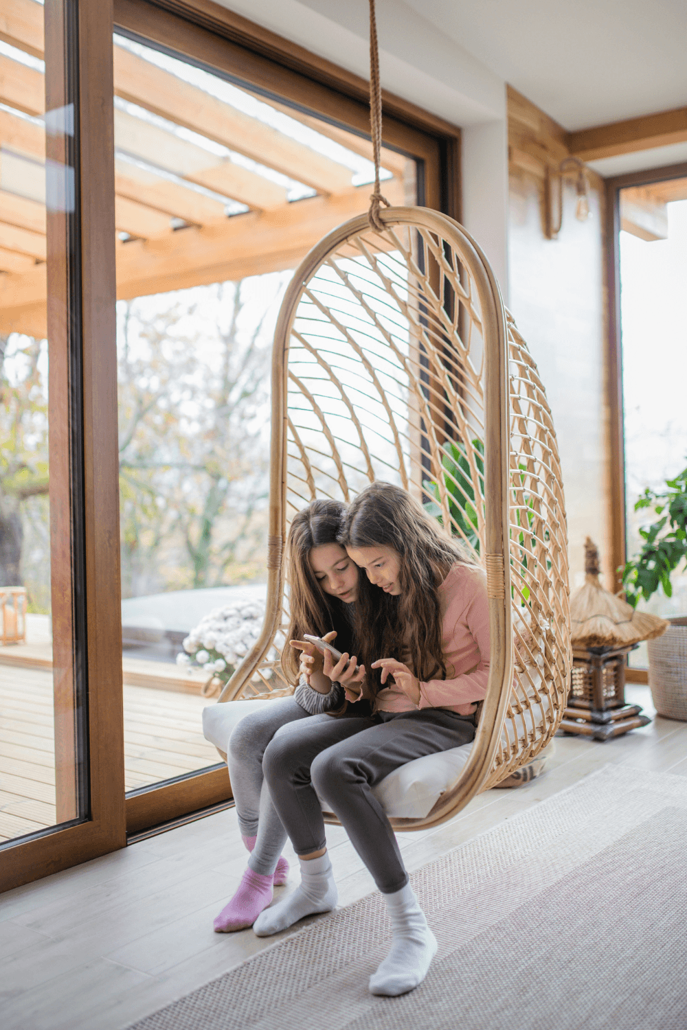 Twin girls looking at mobile phone together
