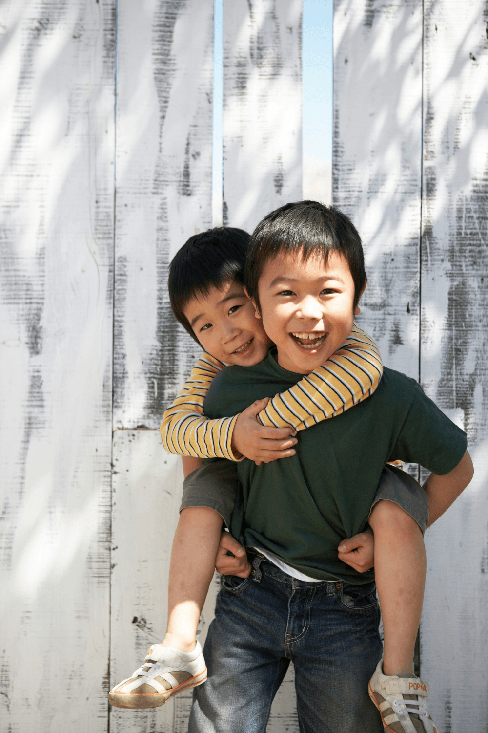 Two happy boys, one giving a piggyback to the other