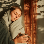 Woman asleep wrapped in green duvet