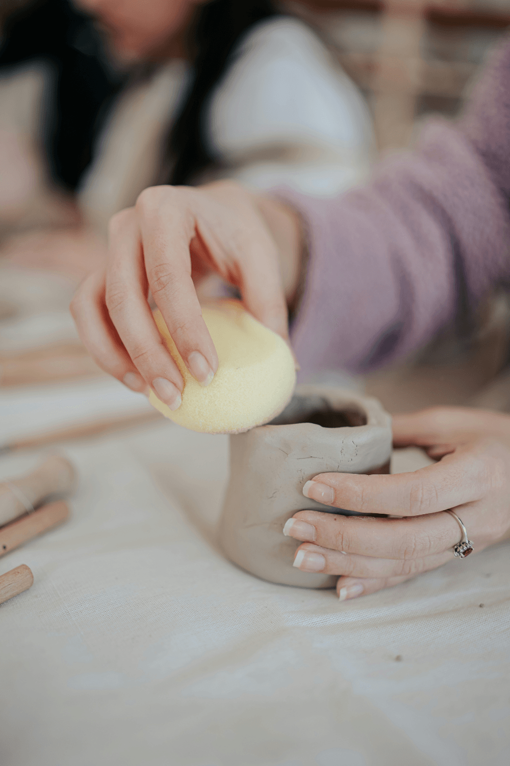 Woman learning to make pottery