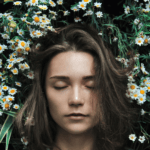 Woman lying on bed of flowers