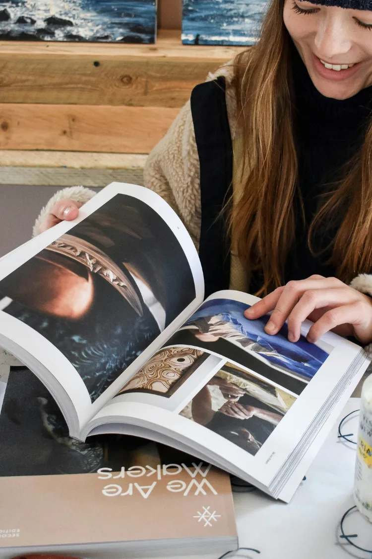Woman reading We Are Makers magazine