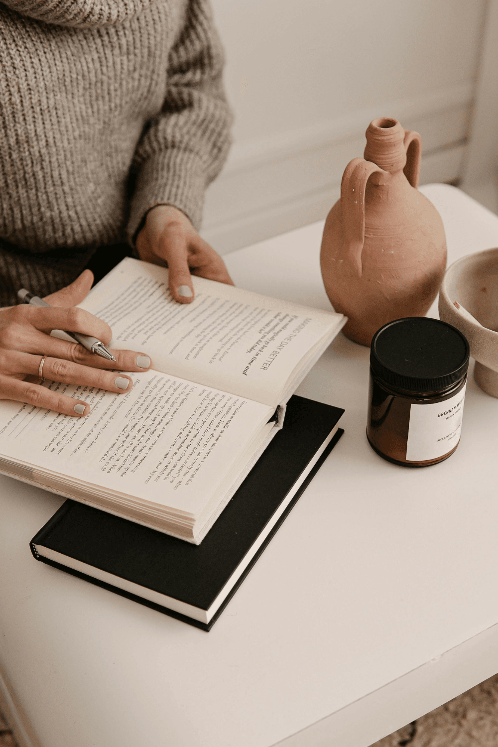 Woman reading book and taking notes