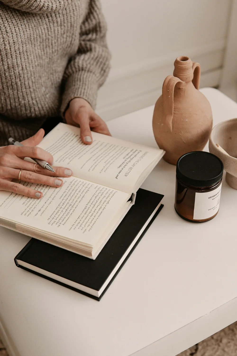 Woman reading book and taking notes