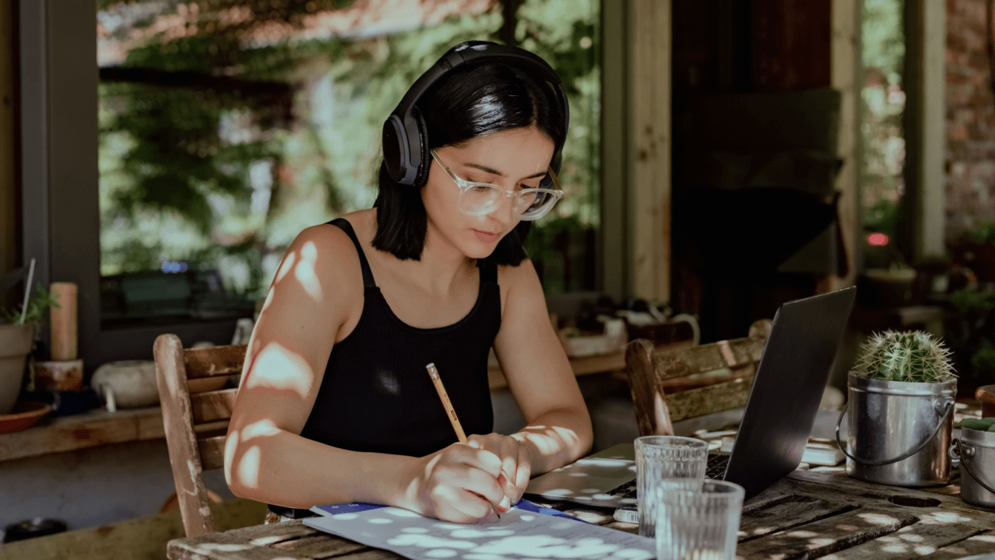 Woman sitting at a table writing notes