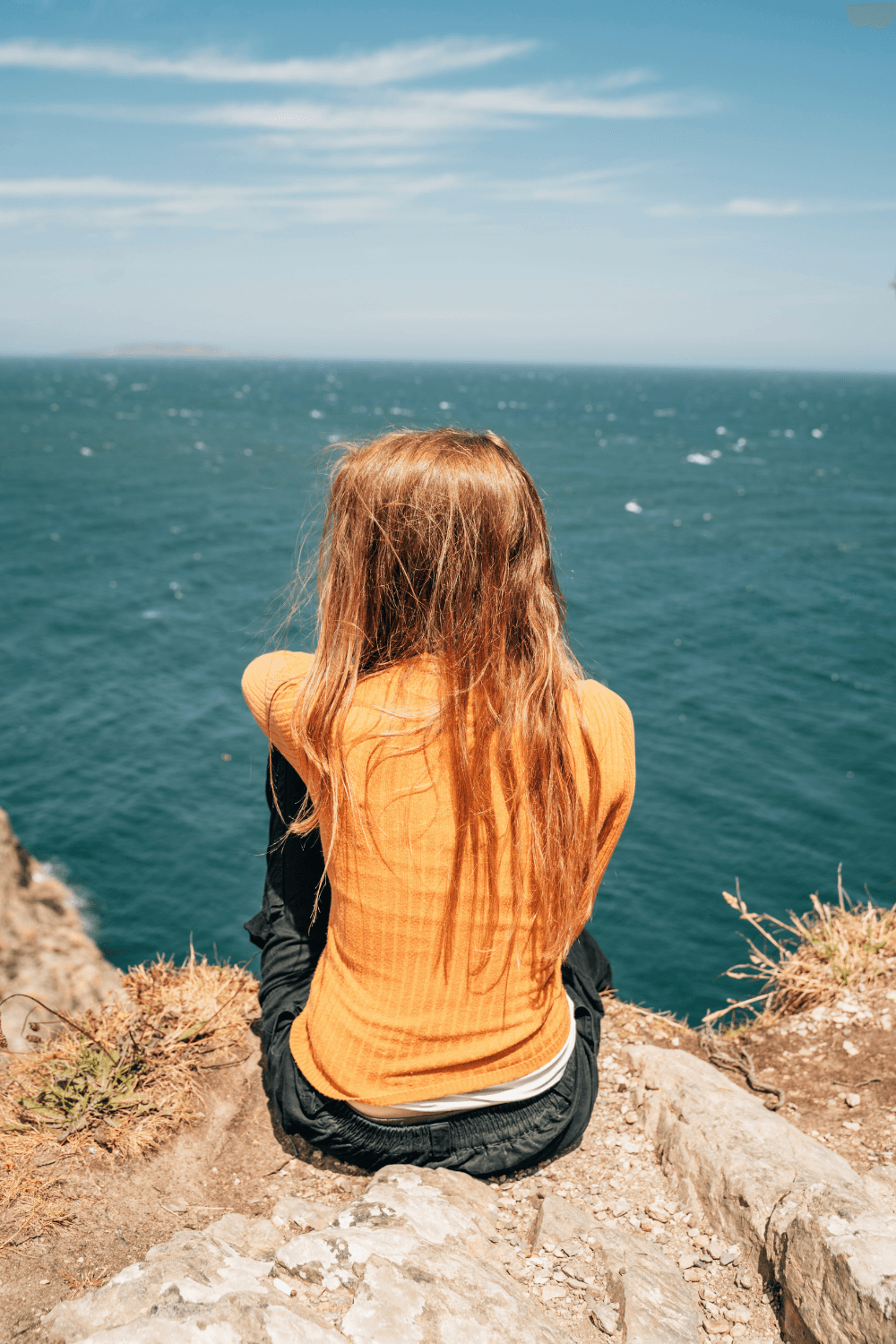Young woman looking out at the ocean