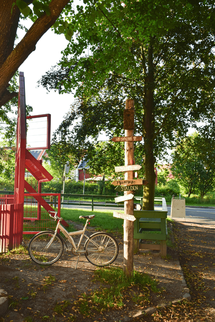 Bike next to sign in Danish Park, Dyssekilde St., Hundested, Denmark