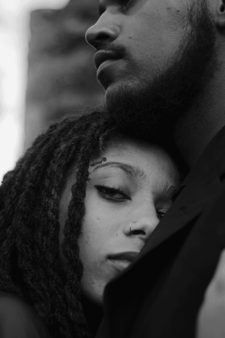 Black and white photo of young couple comforting each other