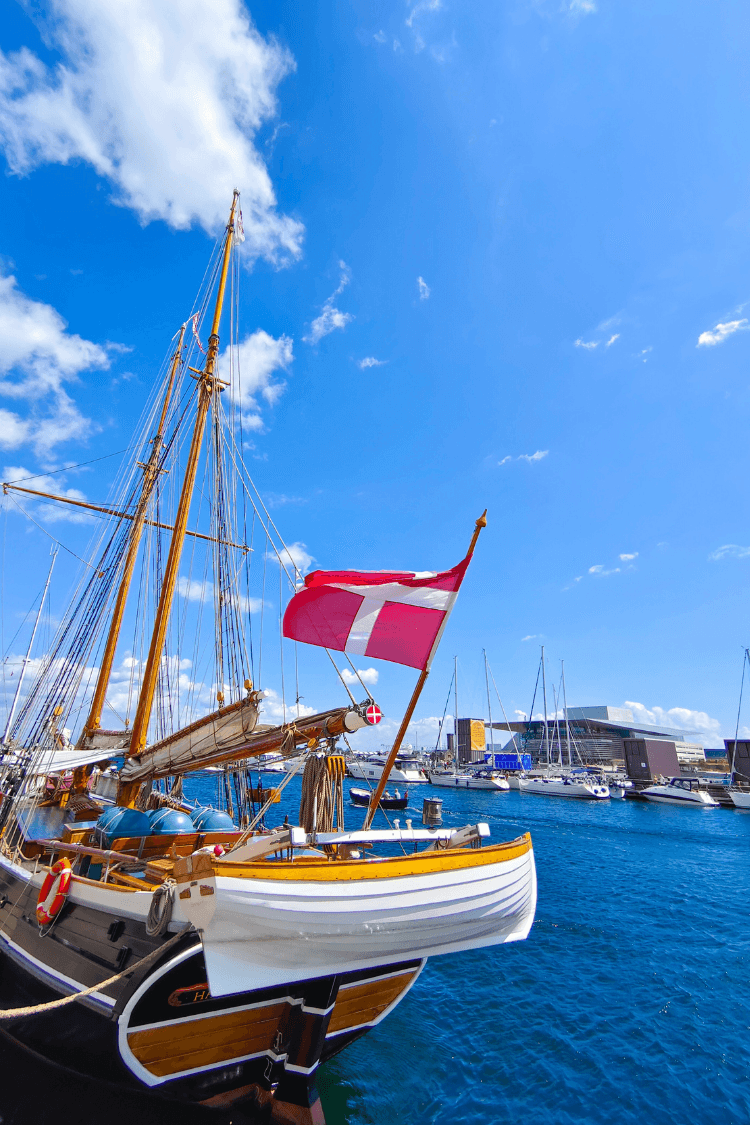 Boat on water, blue skies and danish flag