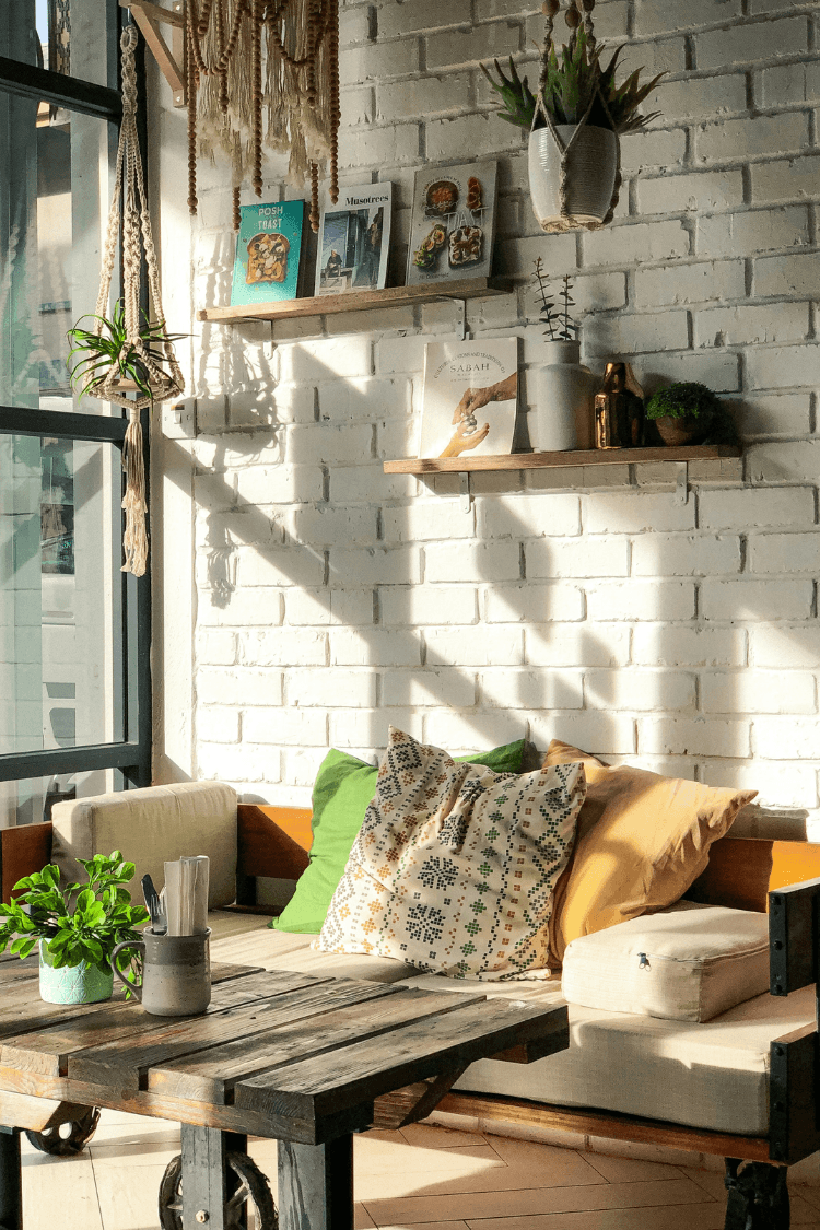 Bright and airy home with sofa, cushion and white brick wall