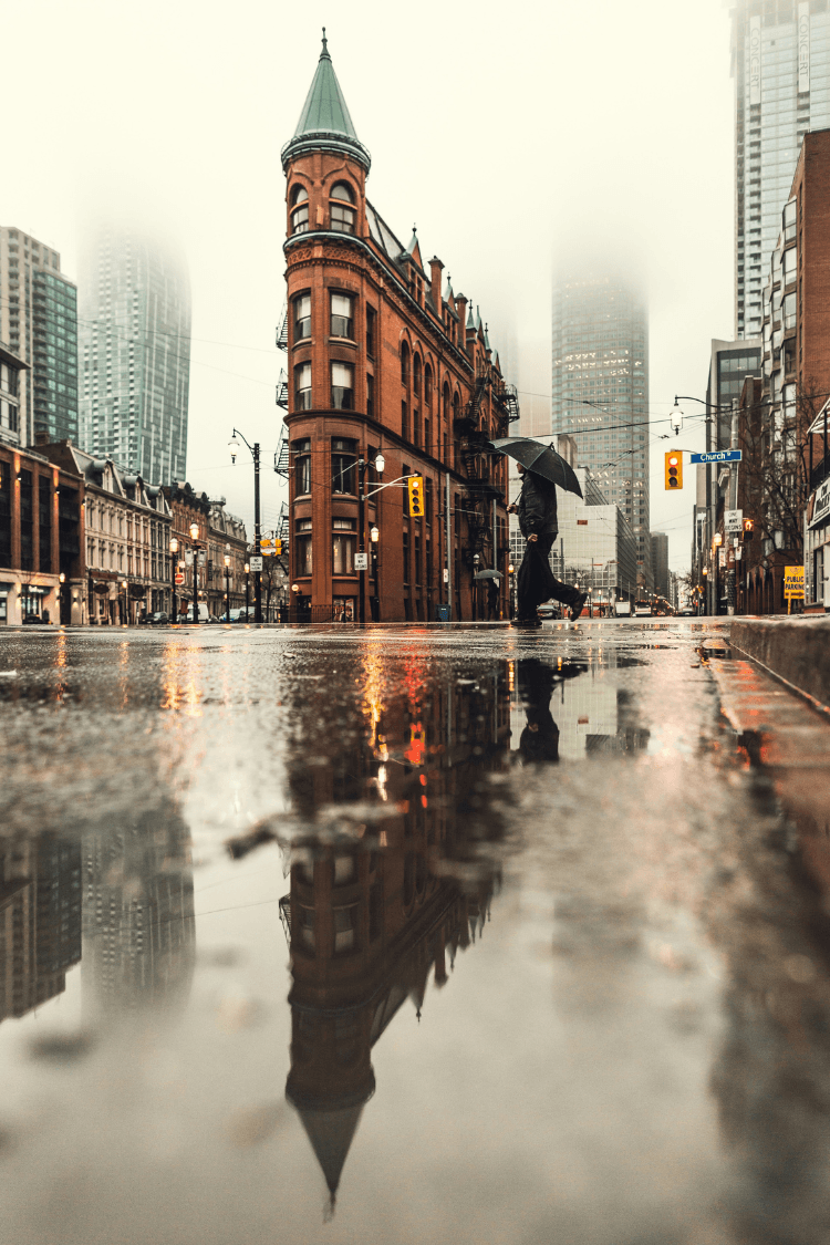 Building reflected in rain water on road