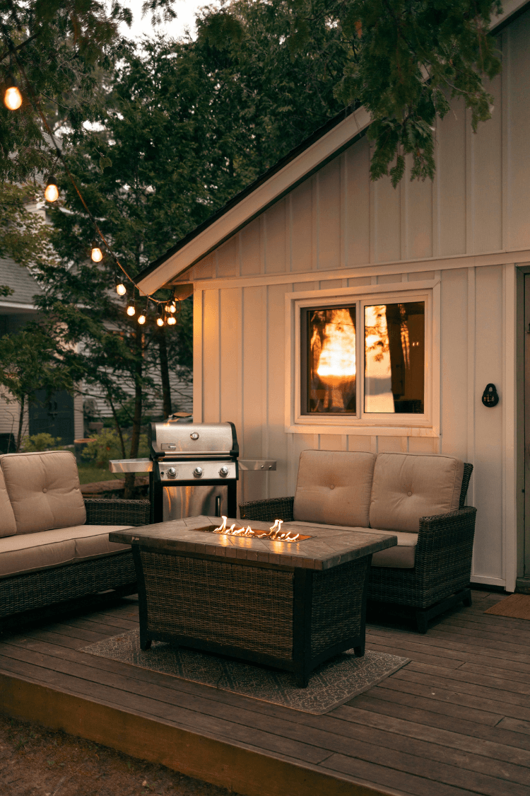 Cozy outdoor space by a white cabin