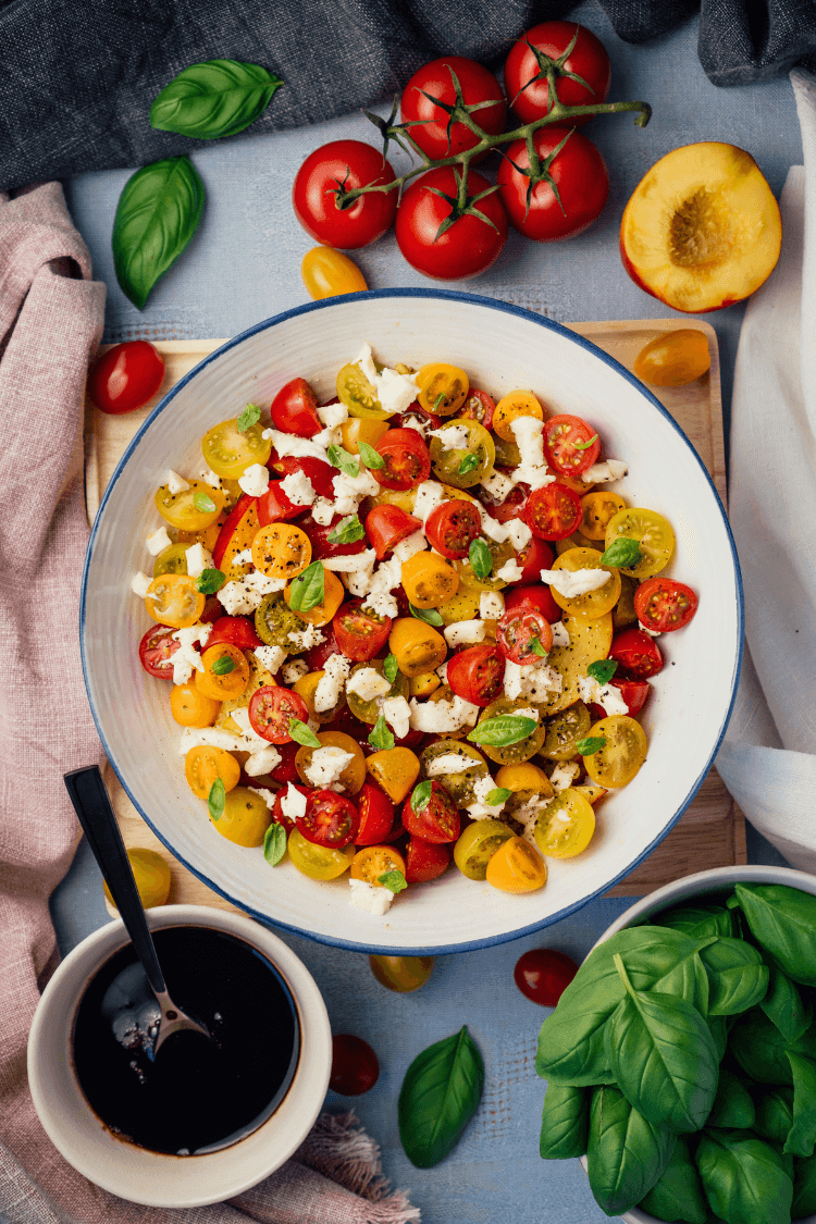 Delicious tomato nectarine salad in white bowl
