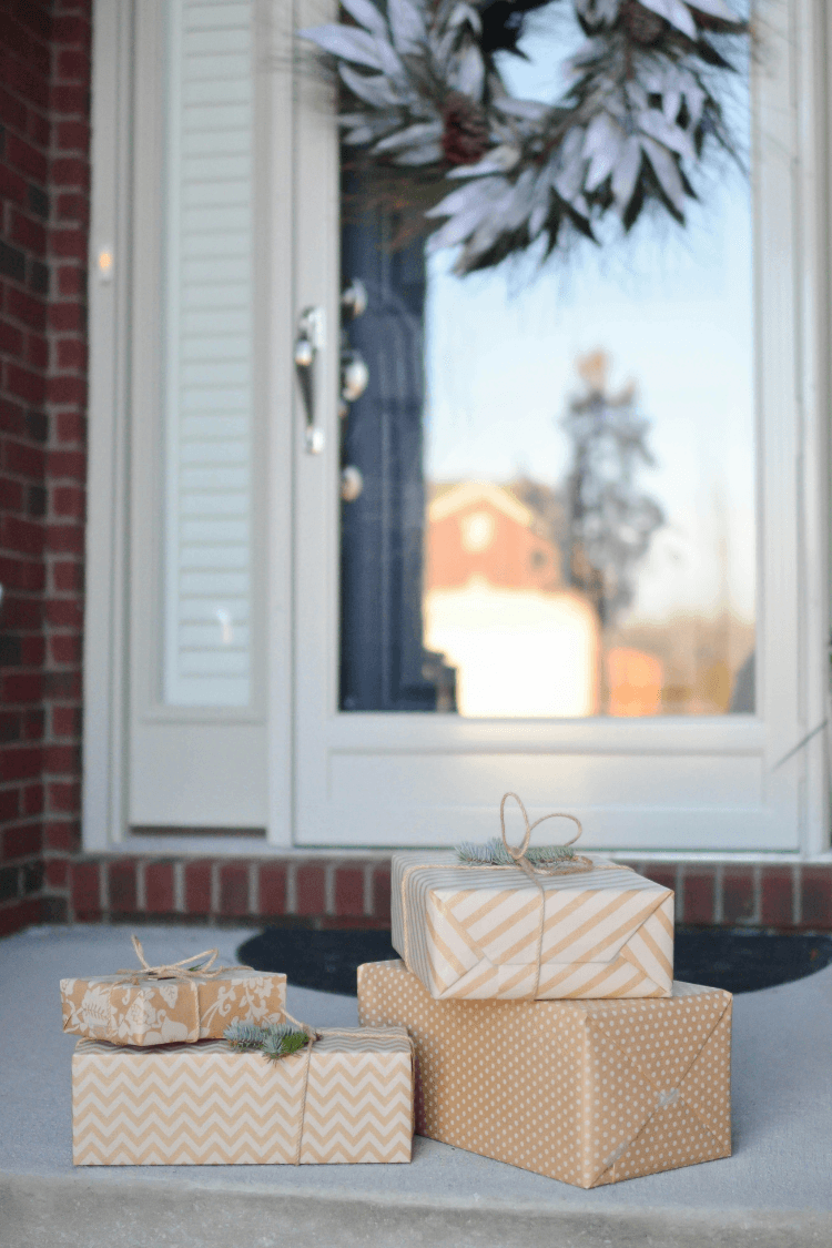 Four gifts in brown wrapping left outside front door