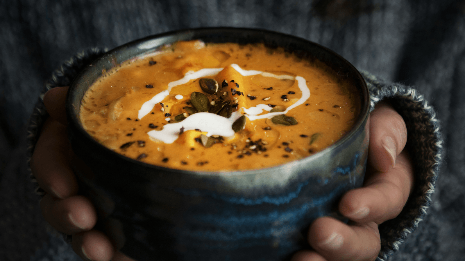 Fresh homemade butternut squash soup in a navy ceramic bowl