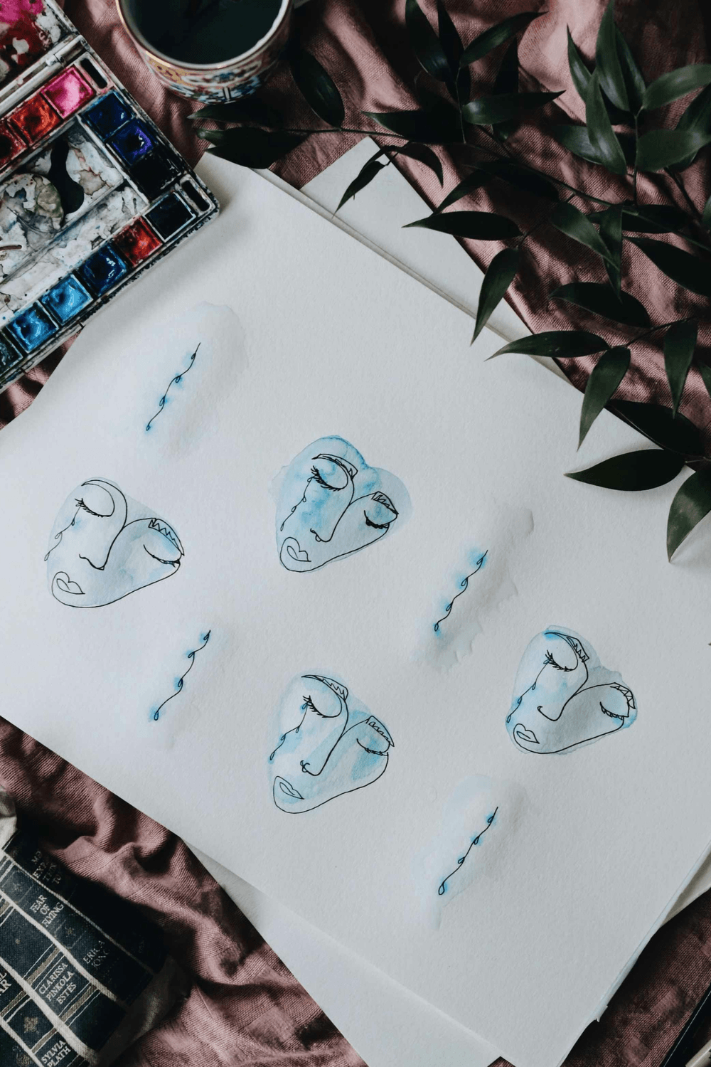 Line drawings of faces with tears on