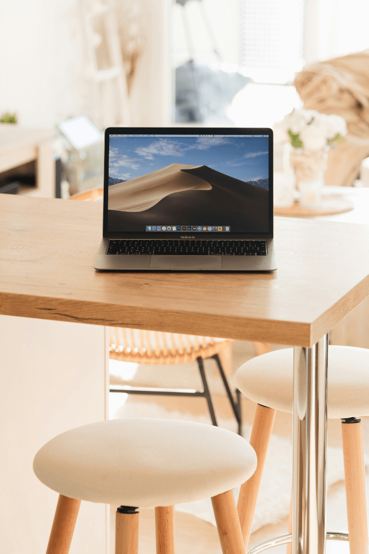 MacBook Pro with image of sand dunes on screensaver