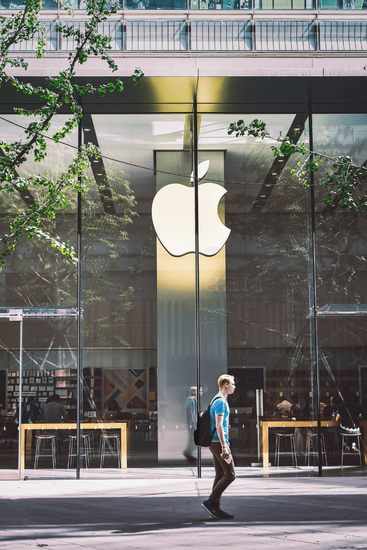 Man walking in front of an Apple office