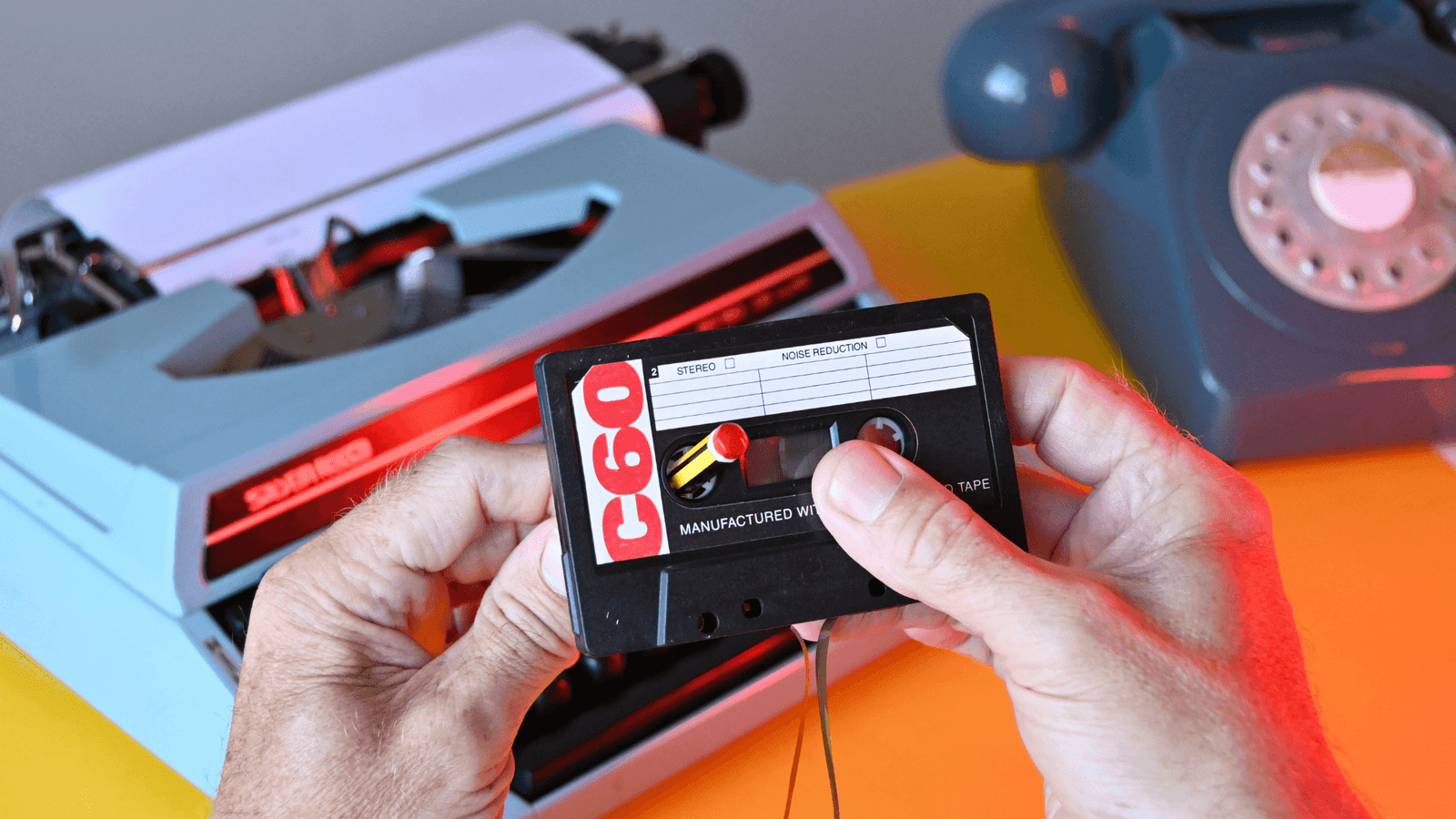 Man winding a casette tape with a pencil