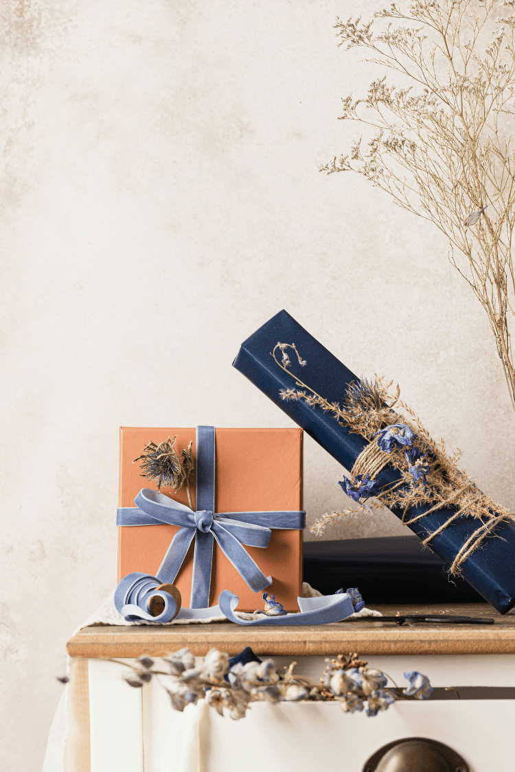 Navy gift next to craft box with blue ribbon