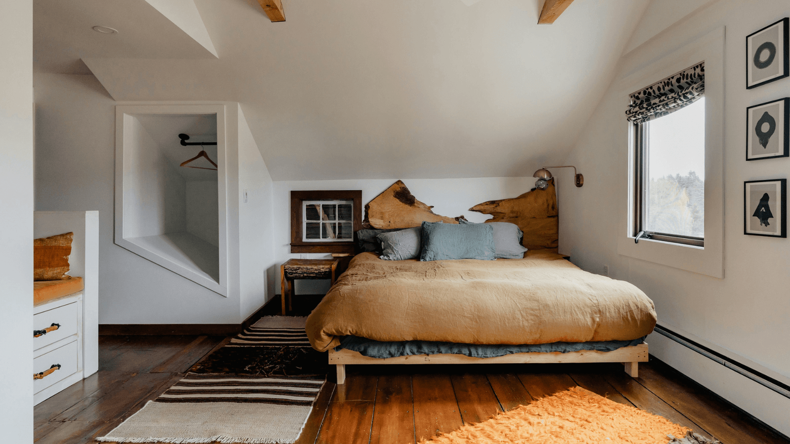 Neatly made bed with brown divers cover and orange rug