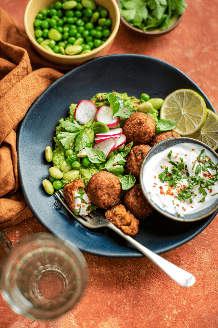 Plate of healthy food including saad, radishes and green beans