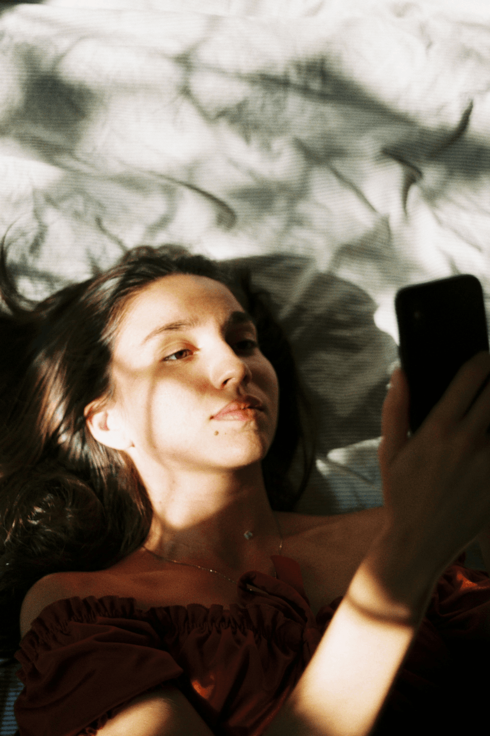 Teenager lying down looking at phone