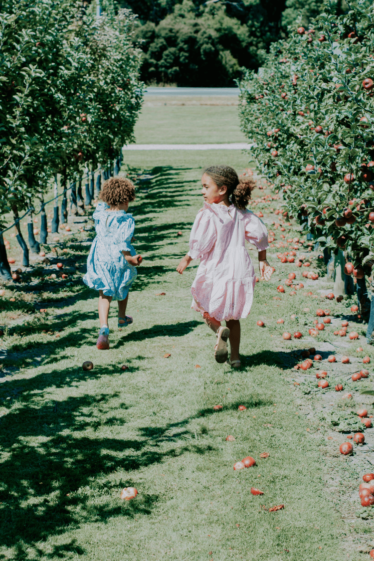 Two girls running in garden