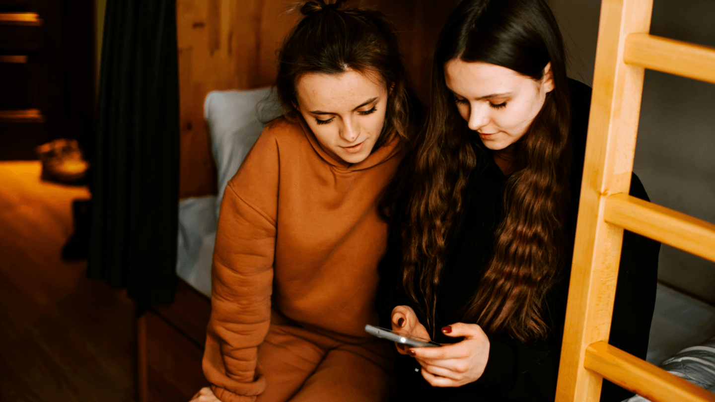 Two teenage girls looking at a phone