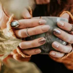 Woman holding grey mug with both hands
