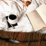 Woman in cosy socks reading next to mug of tea