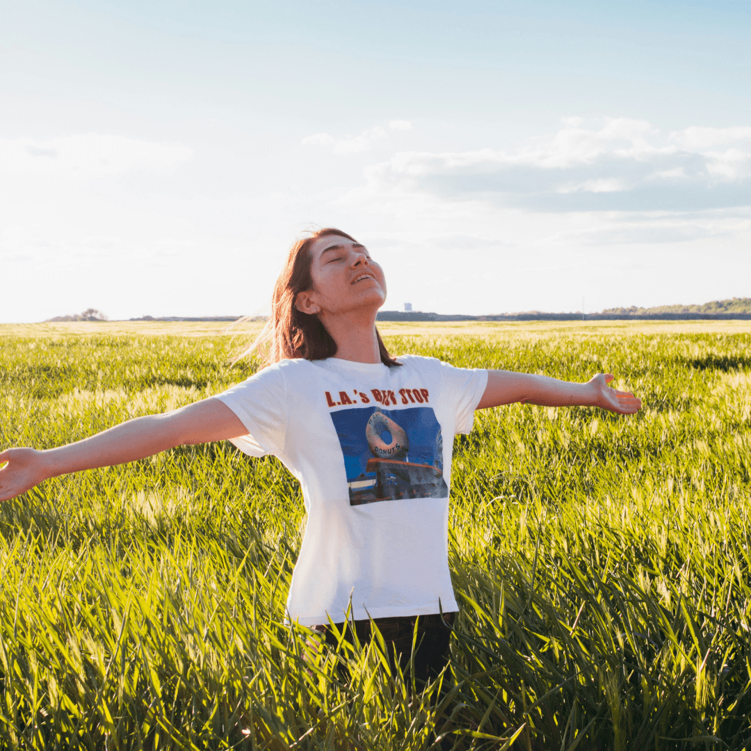 Woman in field enjoying the fresh air in summer