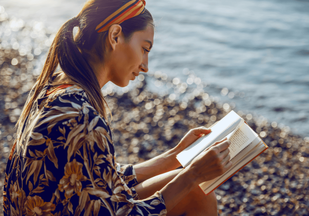 Woman reading a book on the beach