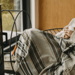 Woman relaxing in front of a log burner