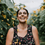 Woman smiling surrounded by plants
