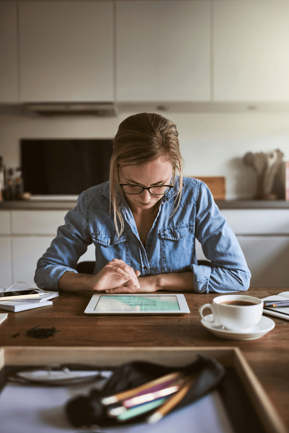 Woman working on iPad at home
